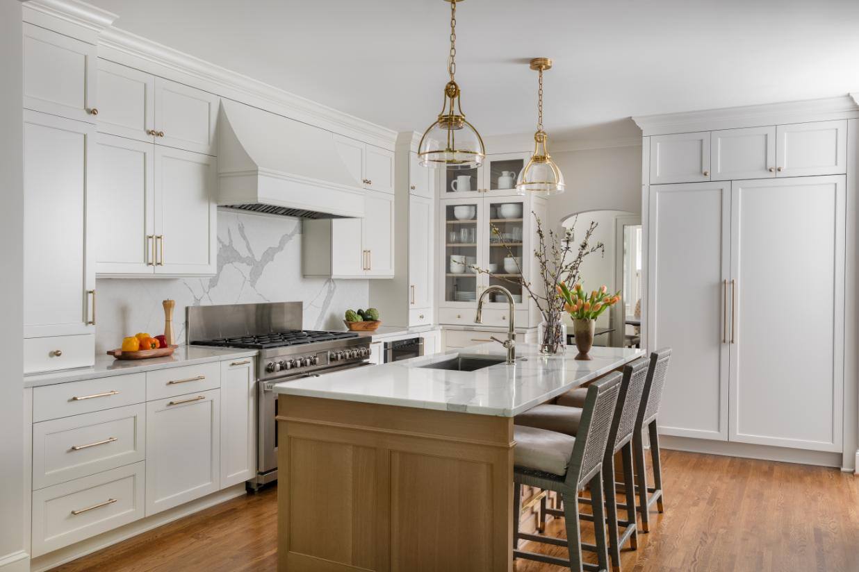 Kitchen with island and barstools in remodeled home by Hopedale Builders Heather Ison Photography